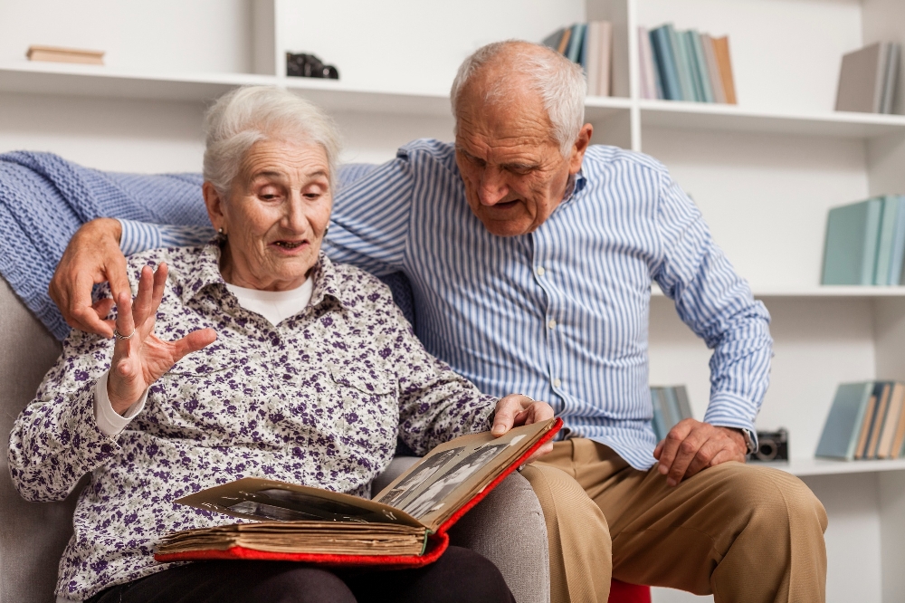 A senior couple looking through a photo album together